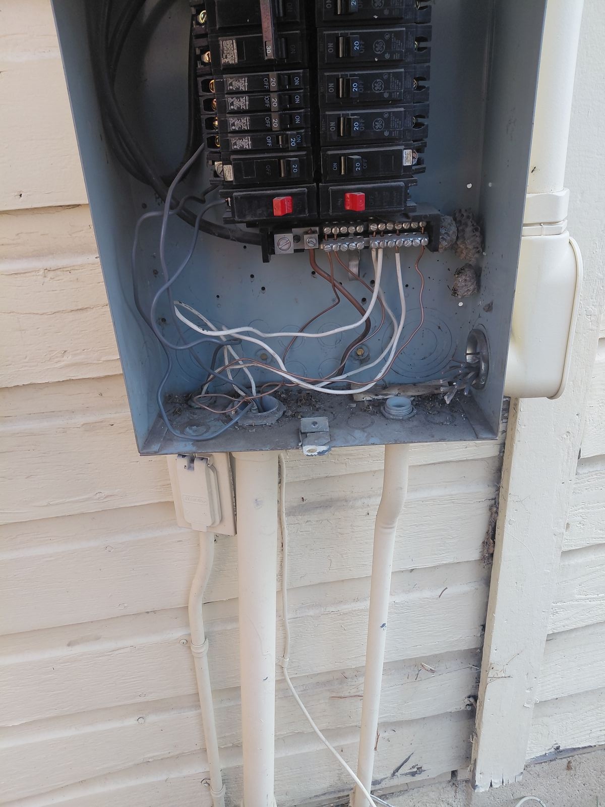 Close-up of an open residential electrical panel during inspection and service.